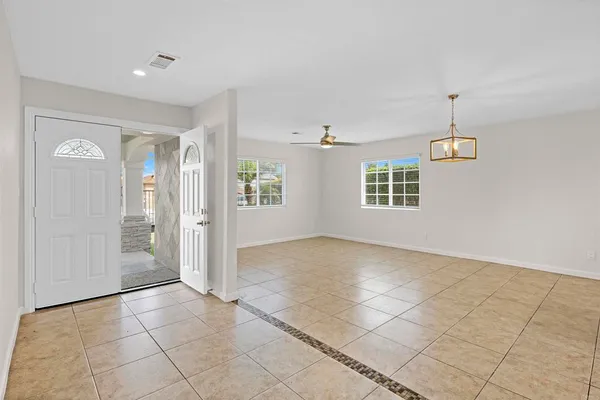 a view of a kitchen with an empty space and a window