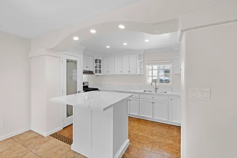 a kitchen with stainless steel appliances a sink stove and cabinets