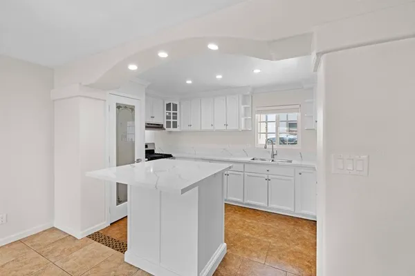 a kitchen with stainless steel appliances a sink stove and cabinets