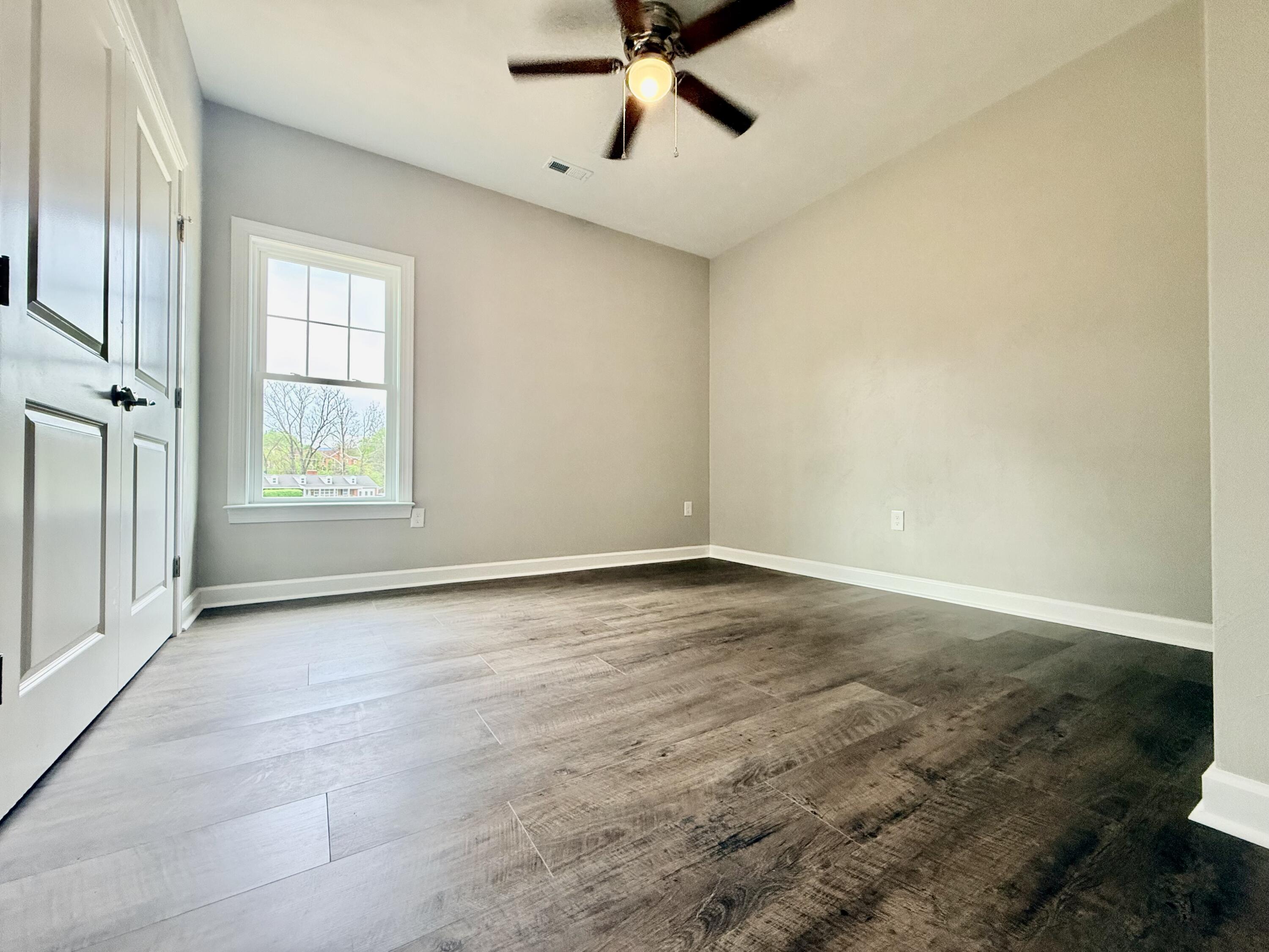 5185 Cove Road Roanoke, VA 24019 - Photo 5 of 18 an empty room with window and ceiling fan