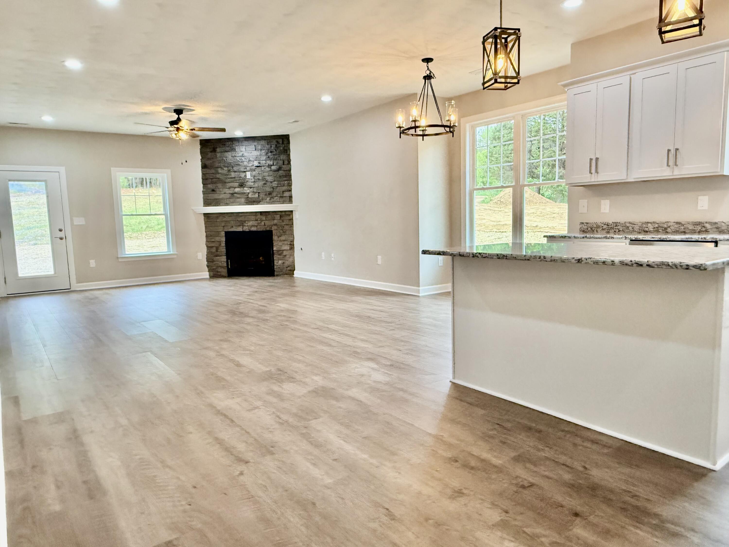 5185 Cove Road Roanoke, VA 24019 - Photo 7 of 18 an empty room with windows and fireplace
