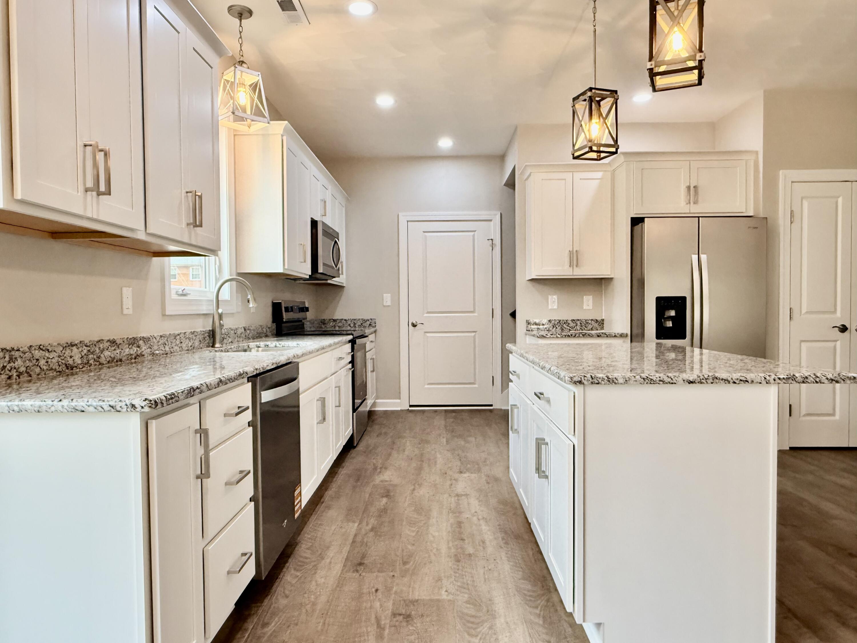 5185 Cove Road Roanoke, VA 24019 - Photo 8 of 18 a large kitchen with stainless steel appliances granite countertop a stove a sink and white cabinets