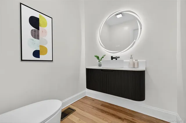 a bathroom with a sink mirror and vanity