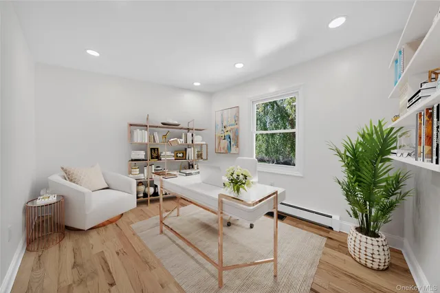 a living room with furniture potted plant and window