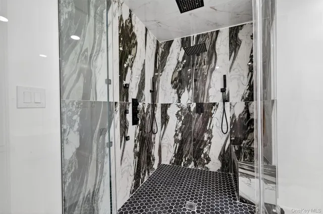 a view of walk in closet with clothes