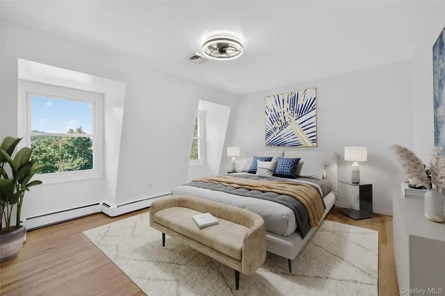 a bedroom with a bed and a potted plant