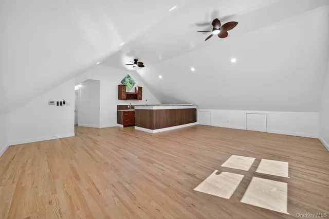 a view of empty room with wooden floor and window