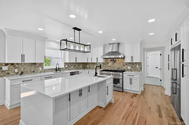 a kitchen with stainless steel appliances granite countertop a stove refrigerator sink and cabinets