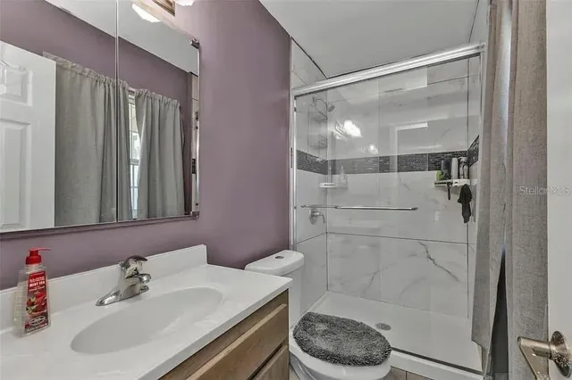a bathroom with a toilet sink and shower