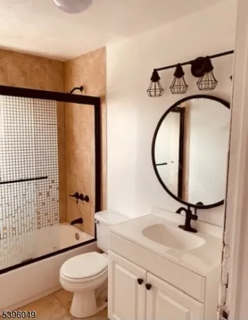 a bathroom with a sink toilet and a mirror