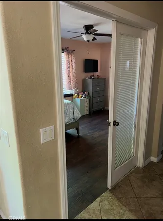 a bed sitting in a bedroom next to a window and a chandelier