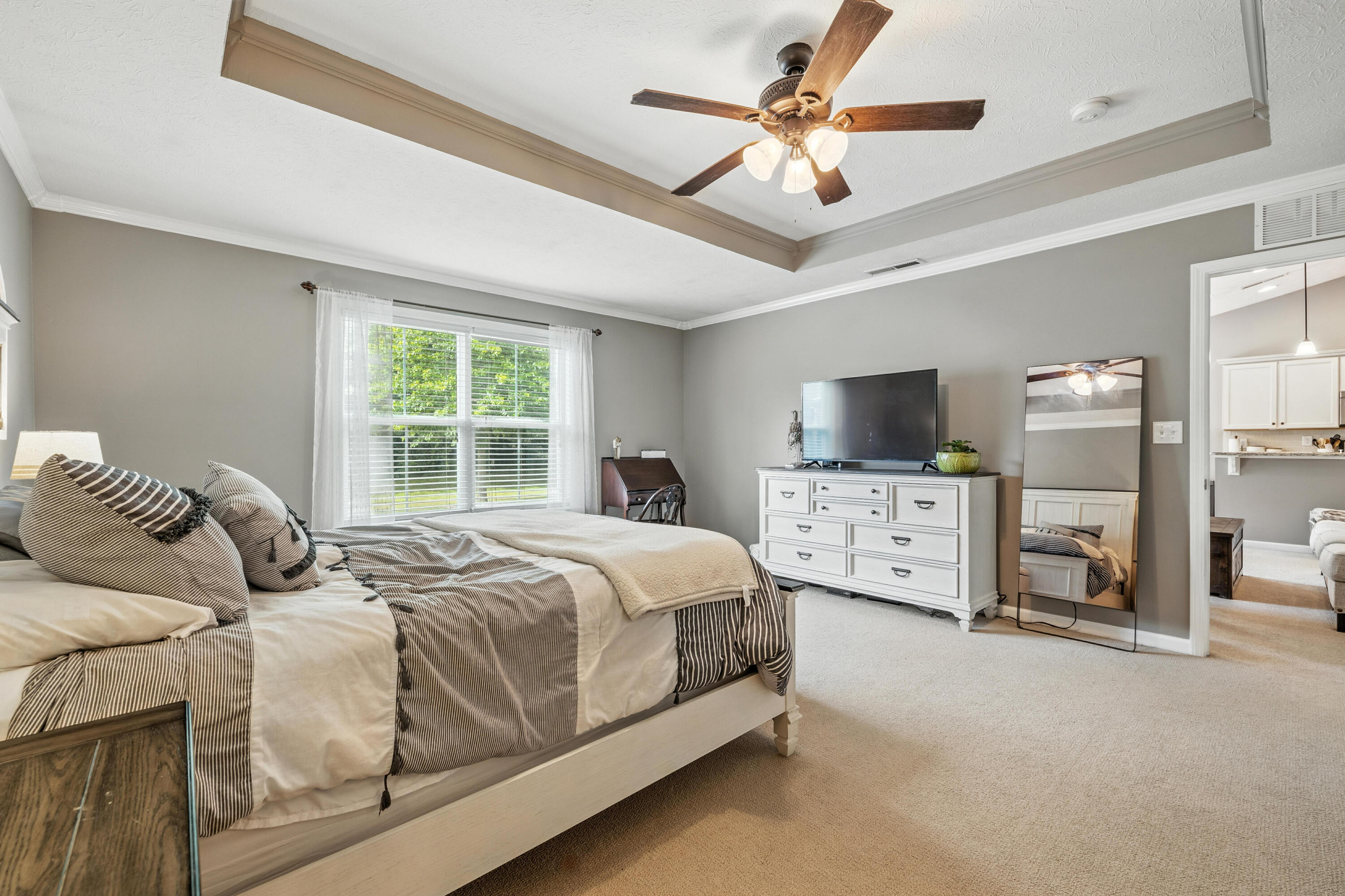 5783 Pebblebrooke Road Whitestown, IN 46075 - Photo 17 of 34 a bedroom with a bed flat screen tv and a large window