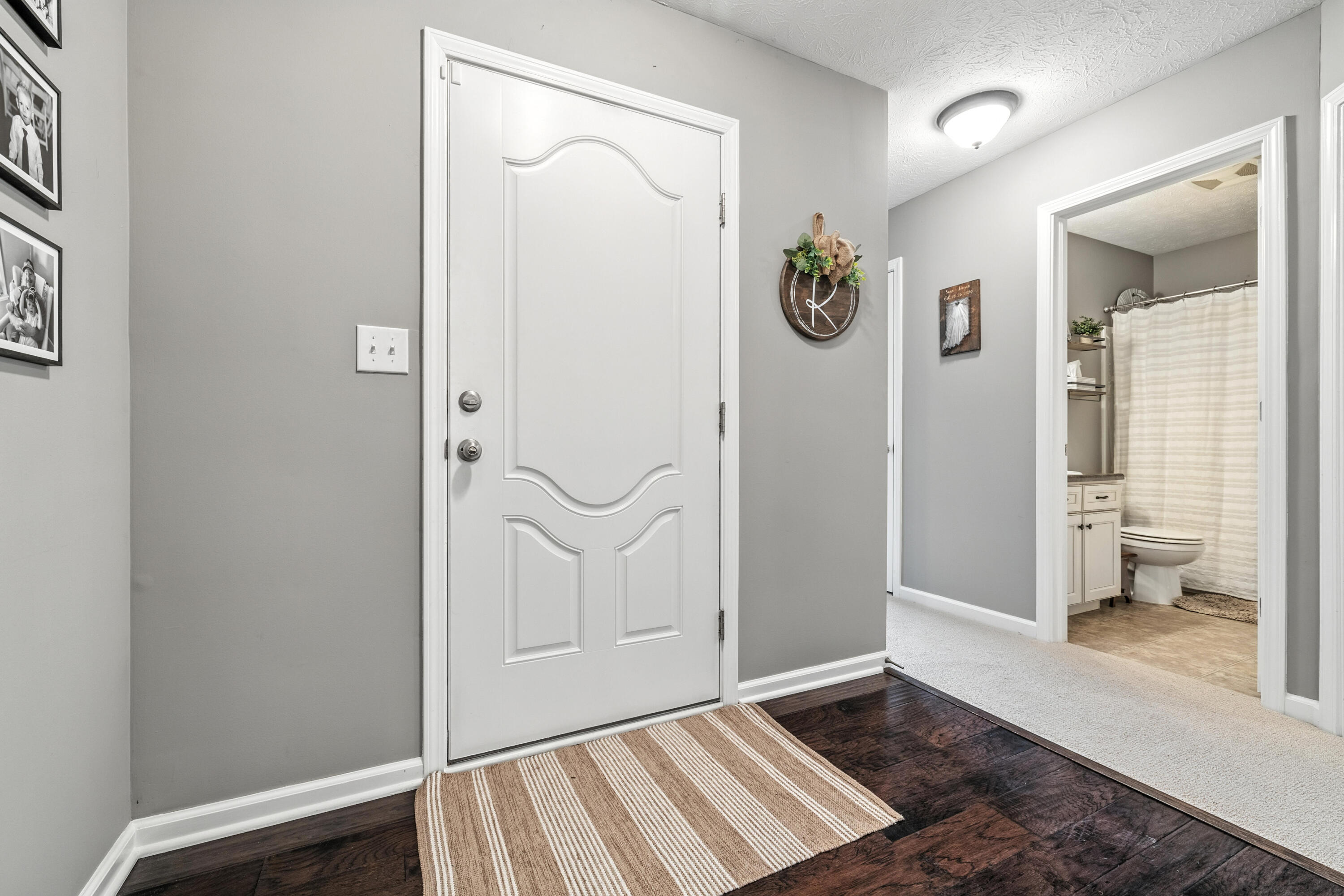 5783 Pebblebrooke Road Whitestown, IN 46075 - Photo 4 of 34 a view of an entryway with wooden floor and a bathroom