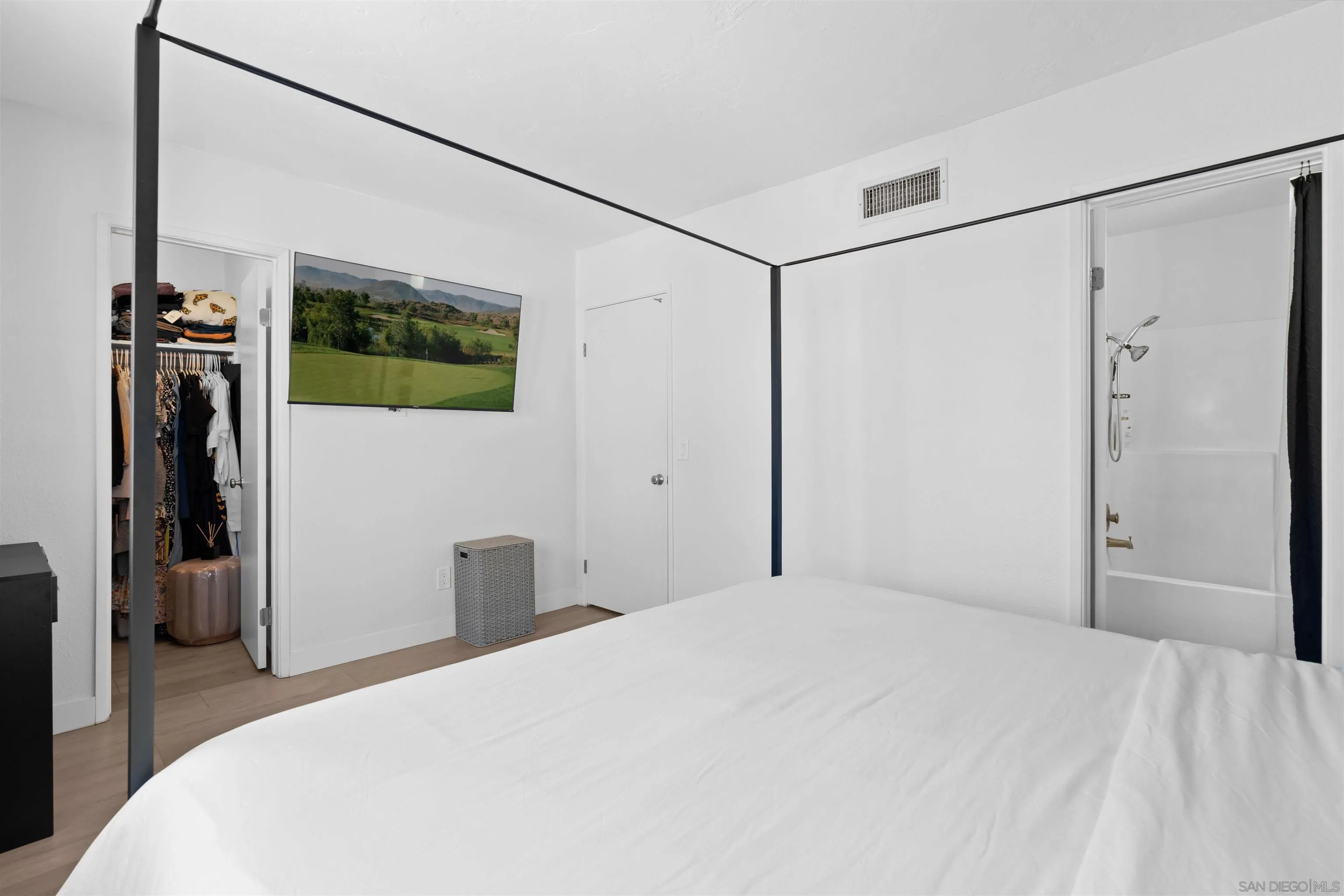 10781 Riderwood Terrace, Unit B Santee, CA 92071 - Photo 23 of 31 a bedroom with a bed and a flat screen tv