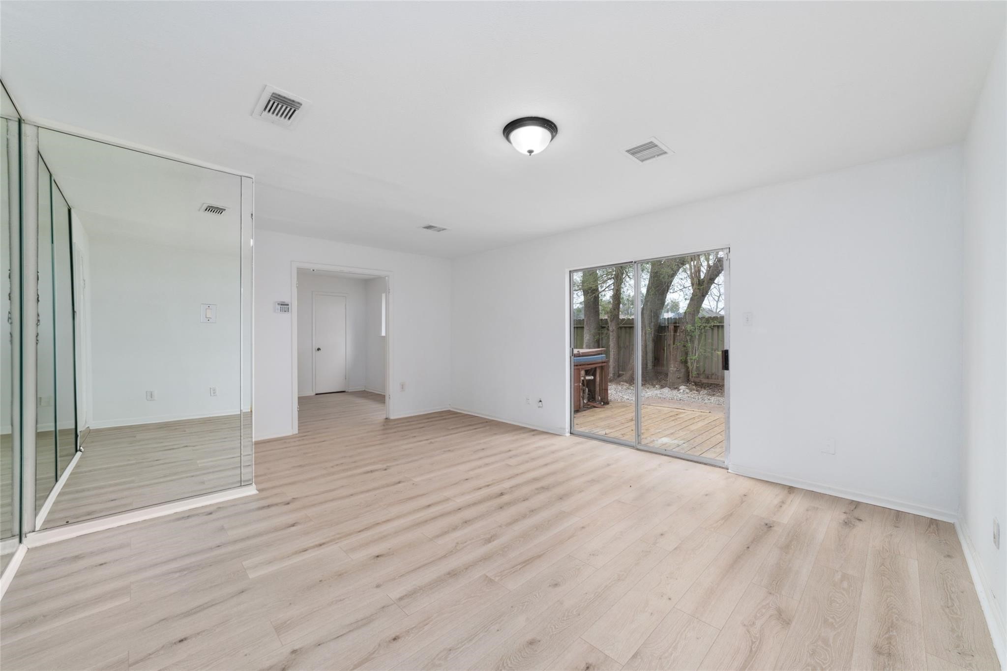 16123 Ridgegreen Drive Houston, TX 77082 - Photo 15 of 21 a view of empty room with wooden floor and fan