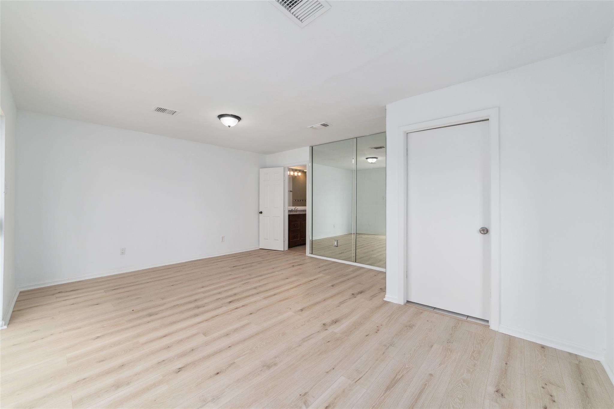 16123 Ridgegreen Drive Houston, TX 77082 - Photo 16 of 21 a view of an empty room with wooden floor