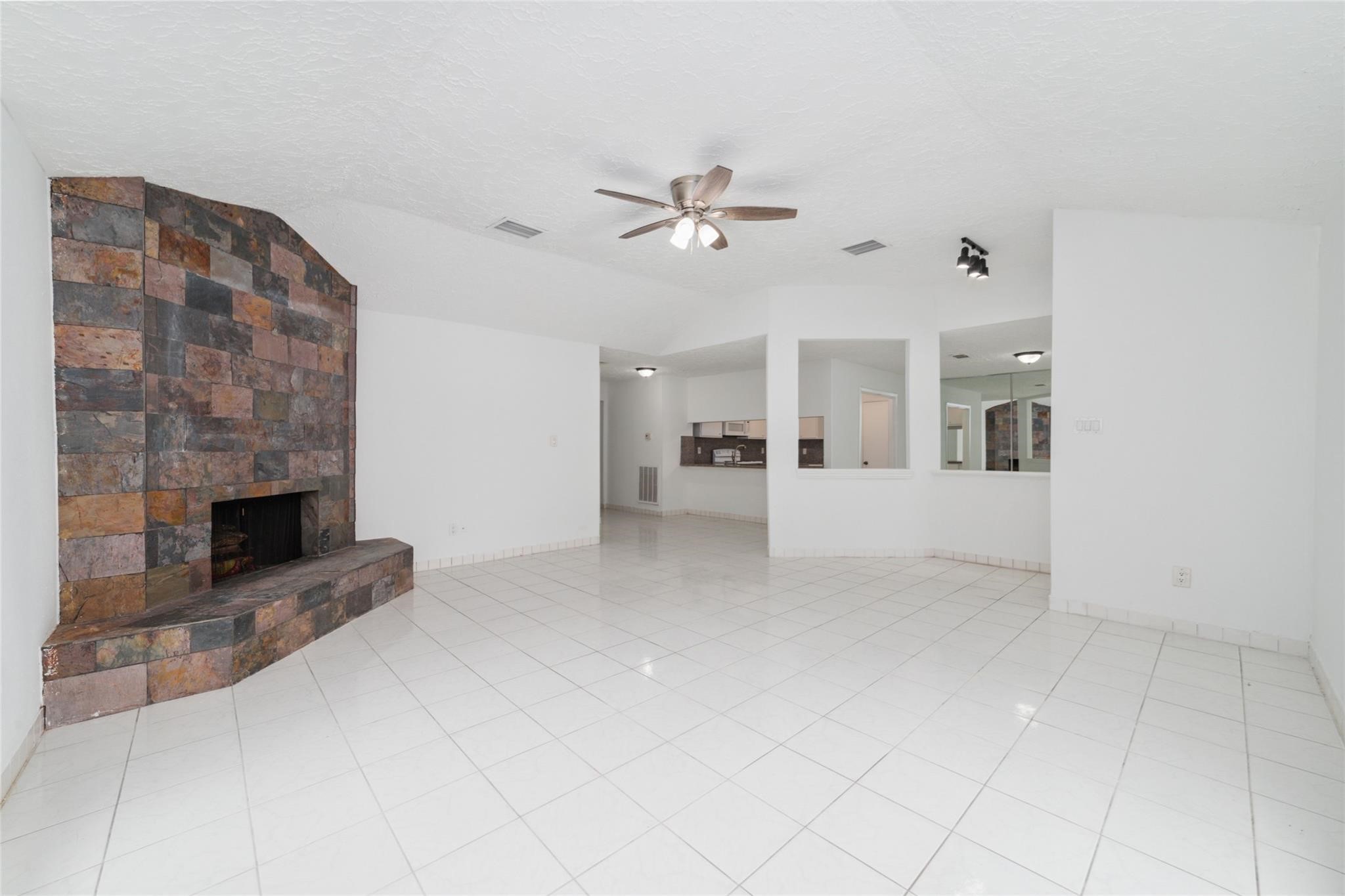 16123 Ridgegreen Drive Houston, TX 77082 - Photo 3 of 21 an empty room with fireplace and windows