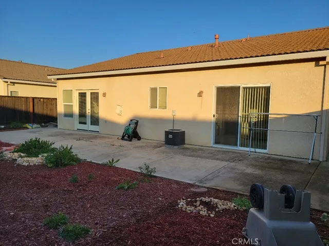a view of a house with backyard and sitting area