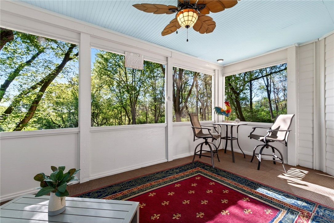 330 South Alpha Bellbrook Road Bellbrook, OH 45305 - Photo 16 of 87 Enjoy tranquil views of lush greenery from this inviting screened porch, perfect for relaxation.