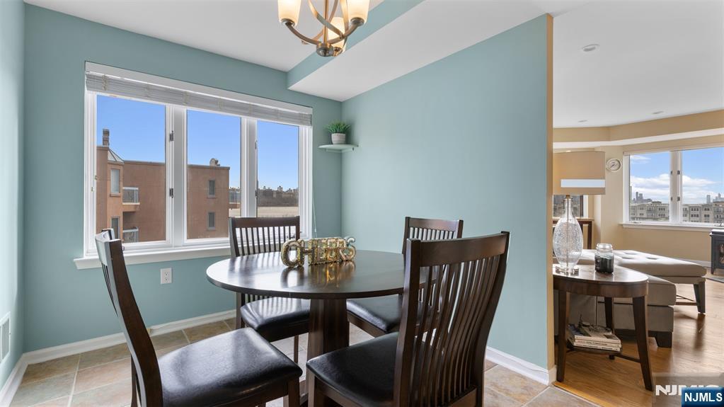 605 Thornton Court, Unit T605 Edgewater, NJ 07020 - Photo 11 of 34 a view of a dining room with furniture window and outside view