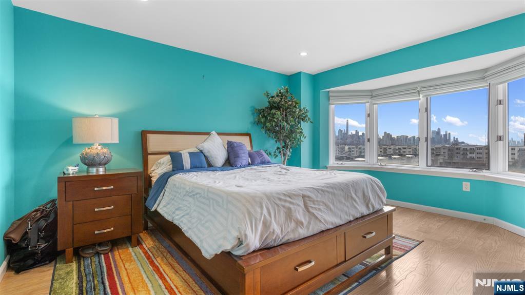 605 Thornton Court, Unit T605 Edgewater, NJ 07020 - Photo 14 of 34 a bedroom with a bed and large window