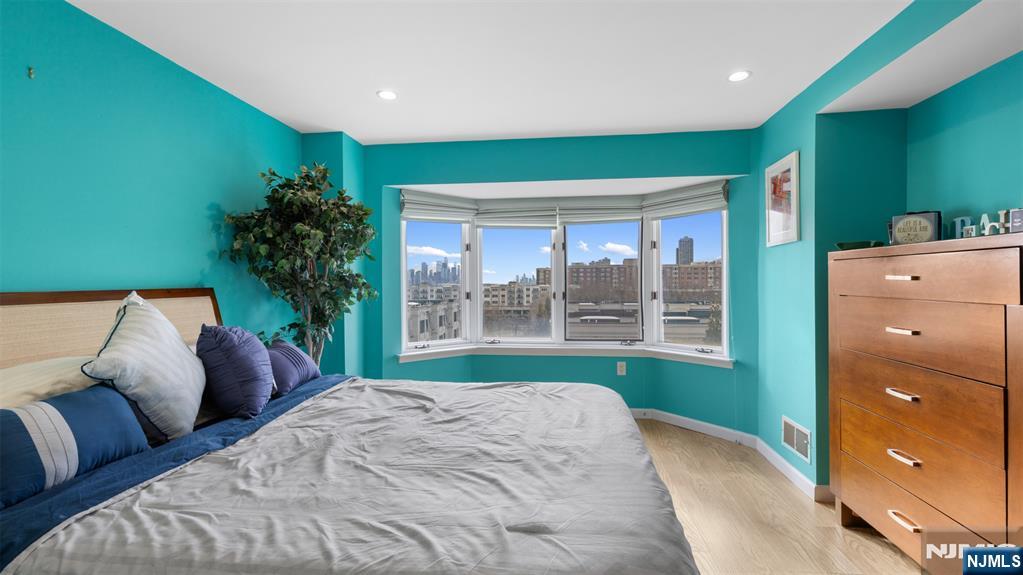 605 Thornton Court, Unit T605 Edgewater, NJ 07020 - Photo 15 of 34 a bed room with a bed and a large window