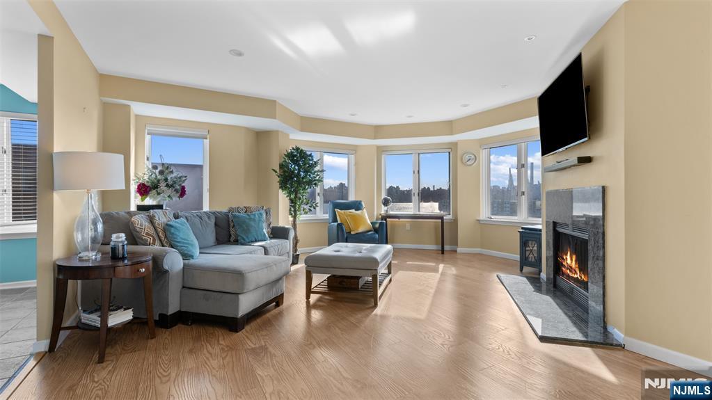 605 Thornton Court, Unit T605 Edgewater, NJ 07020 - Photo 2 of 34 a living room with furniture and a flat screen tv