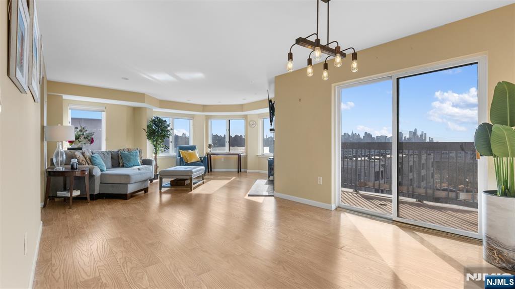 605 Thornton Court, Unit T605 Edgewater, NJ 07020 - Photo 5 of 34 a living room with furniture and a chandelier