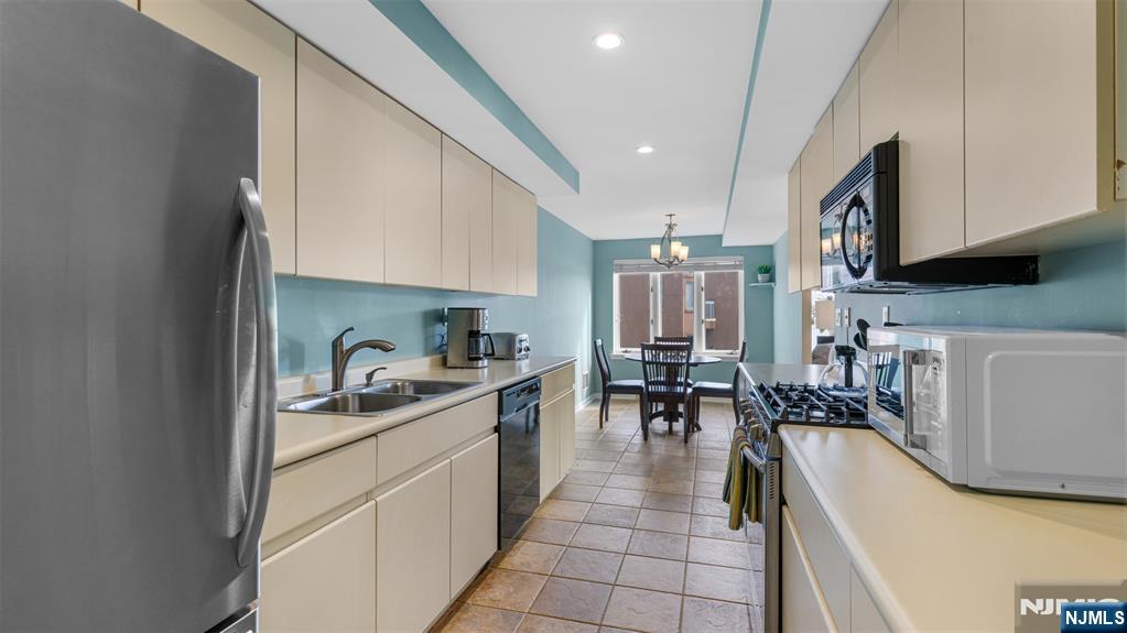 605 Thornton Court, Unit T605 Edgewater, NJ 07020 - Photo 8 of 34 a kitchen with lots of counter top space and furniture
