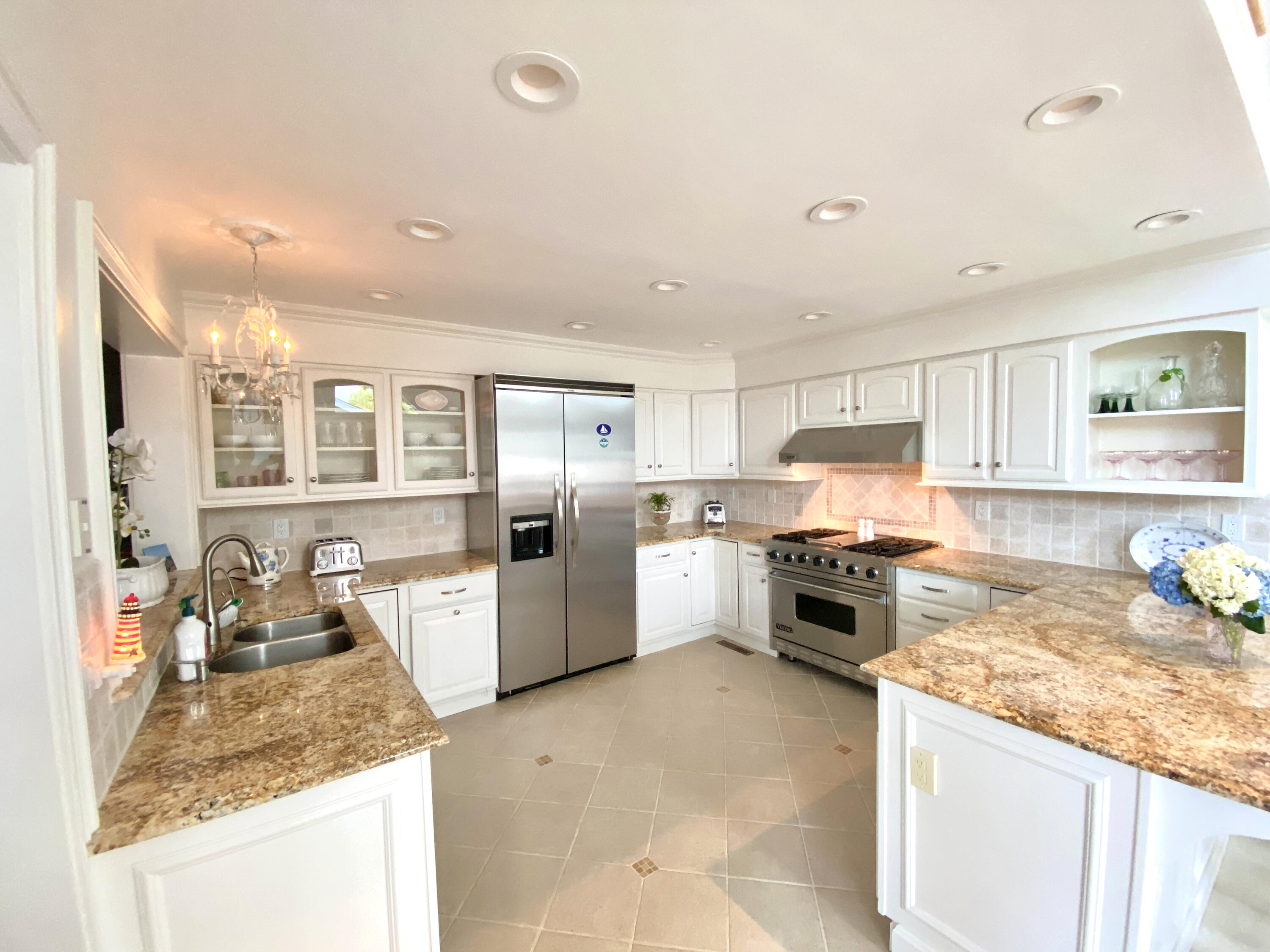 58 Roton Avenue Rowayton, CT 06853 - Photo 13 of 35 a kitchen with stainless steel appliances granite countertop a stove top oven a sink a refrigerator and white cabinets