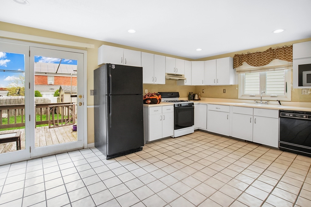 55 Chalmers Street Springfield, MA 01118 - Photo 6 of 17 a kitchen with stainless steel appliances granite countertop a refrigerator and a sink