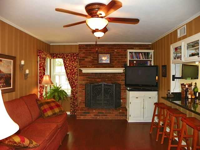 178 North Yates Road Memphis, TN 38120 - Photo 2 of 12 a living room with furniture a flat screen tv and a fireplace