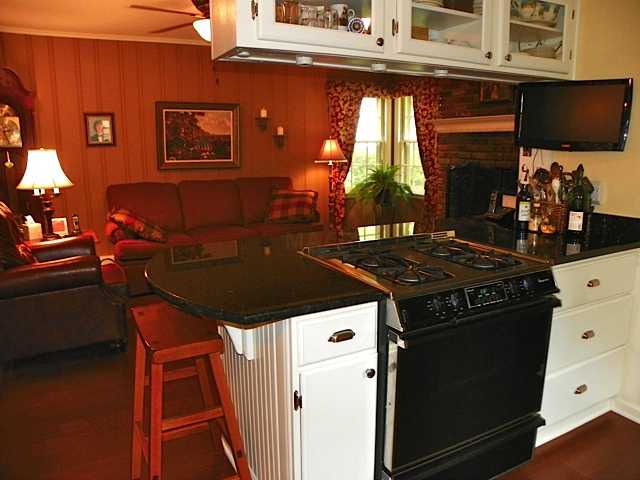 178 North Yates Road Memphis, TN 38120 - Photo 3 of 12 a kitchen with a stove and a microwave