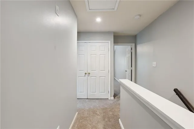 a view of hallway with bathroom
