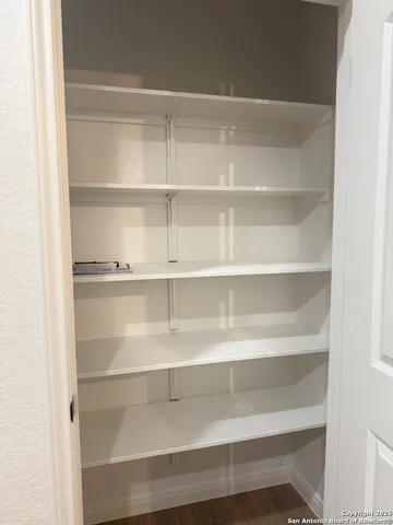 a view of walk in closet with empty racks
