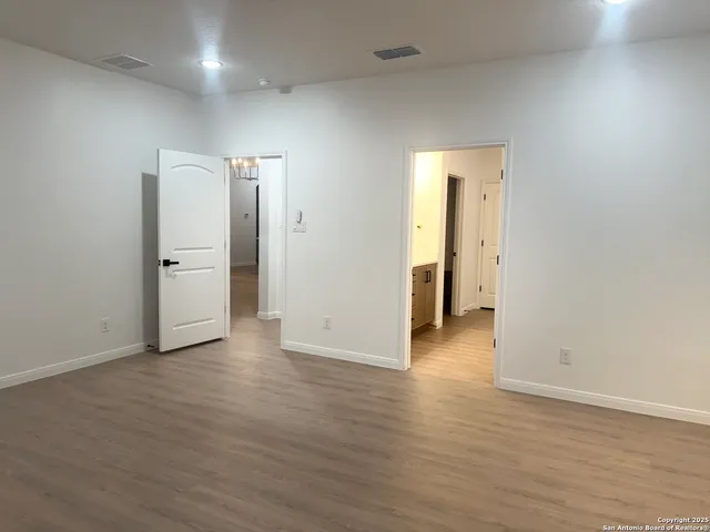 an empty room with wooden floor and closet