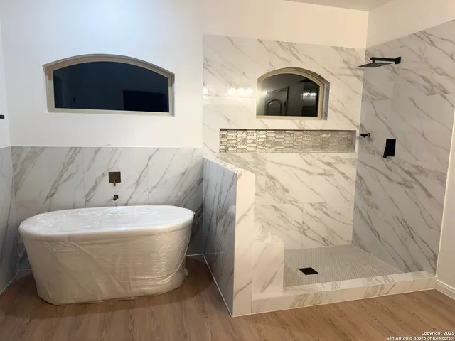 a white bath tub sitting in a bathroom
