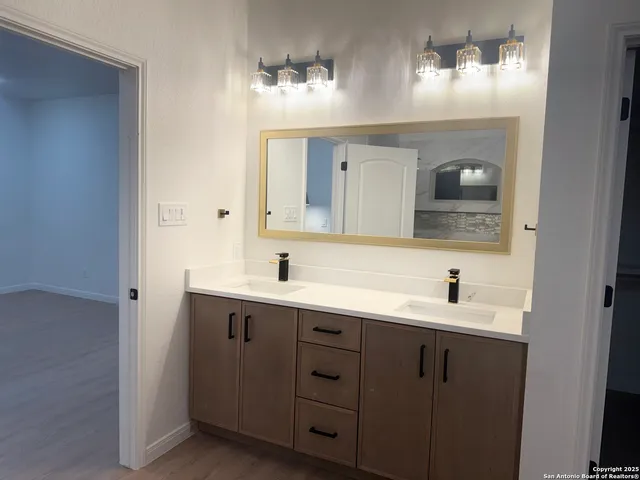 a bathroom with a double vanity sink and mirror