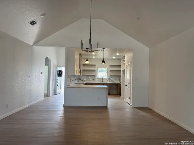 a large kitchen with a wooden floor