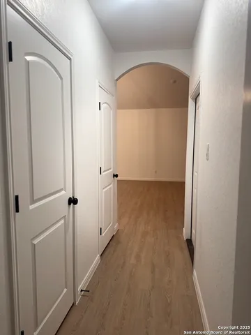 a view of a room with wooden floor