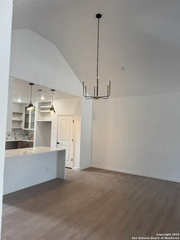 a view of a kitchen with a sink and white cabinets