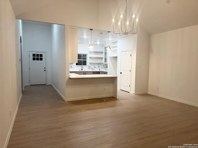 a view of kitchen with refrigerator sink and cabinets