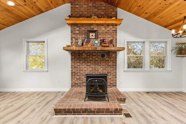 a living room with a fireplace and a wooden floor