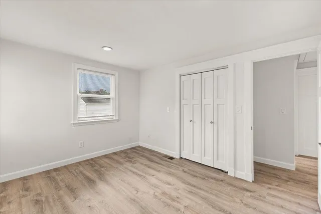 a view of a livingroom with wooden floor and closet area