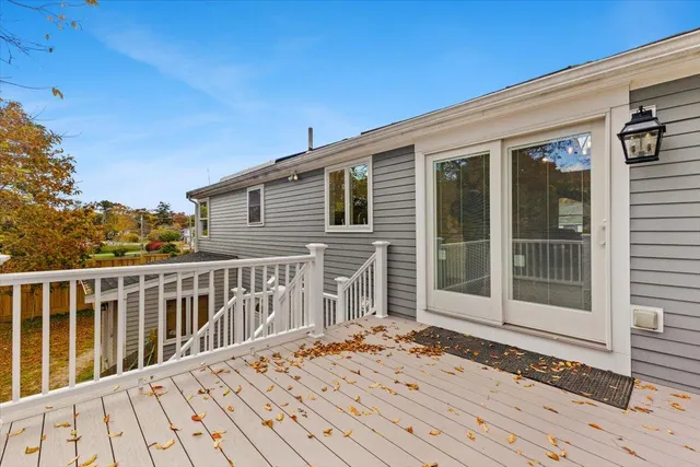 a view of a house with a wooden deck