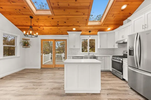 a kitchen with stainless steel appliances granite countertop a stove and a refrigerator