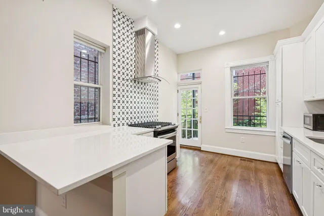 a kitchen with a stove a sink and a refrigerator