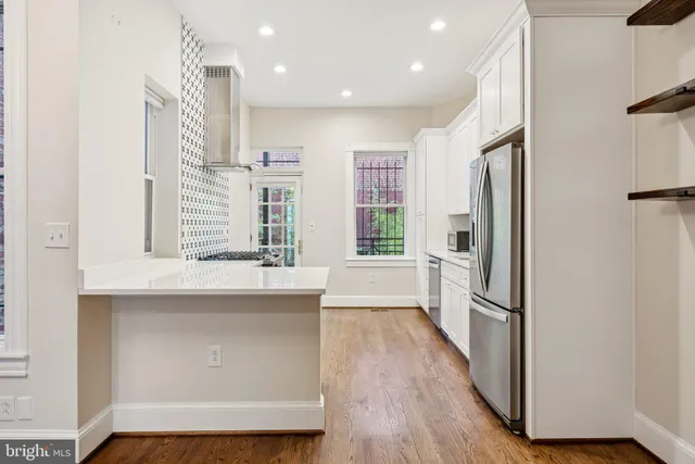 a view of a kitchen cabinets and wooden floor
