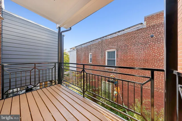 a view of balcony with wooden floor and fence