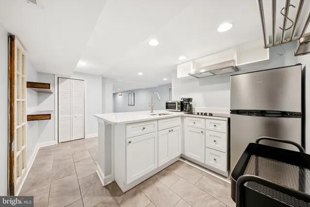 a kitchen with a refrigerator and a sink